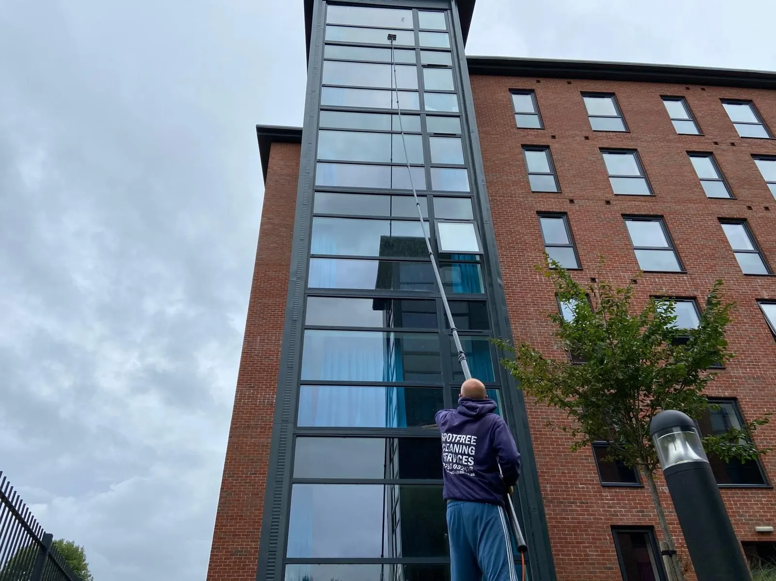 A SPOTFREE van on site at a commercial window cleaning job