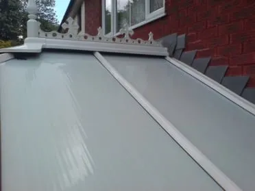 The same conservatory roof after cleaning, the panels clear and the cresting white
