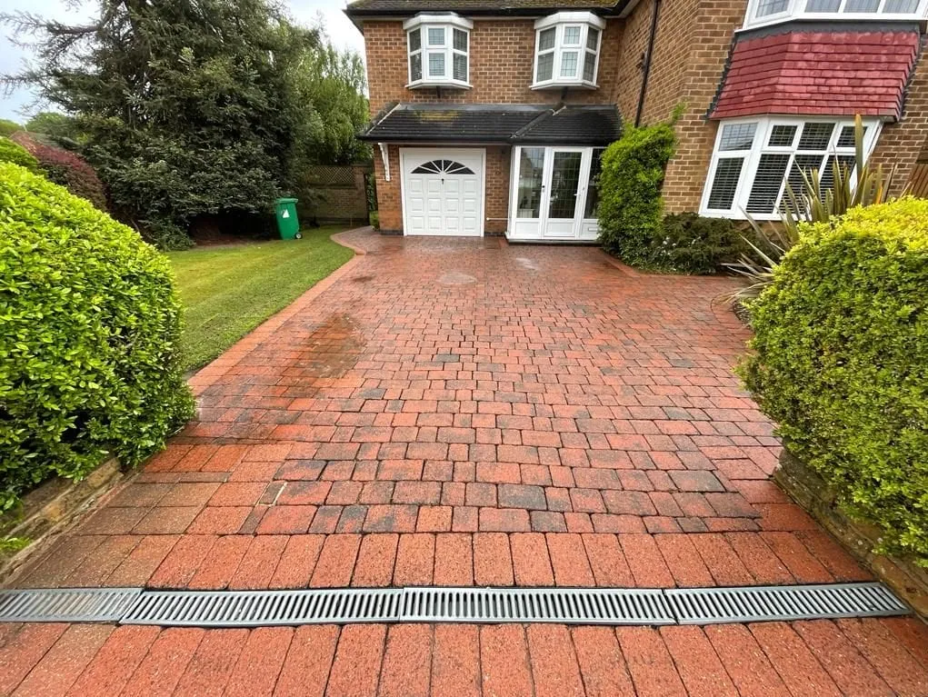 The same block-paved driveway after cleaning, back to its original red