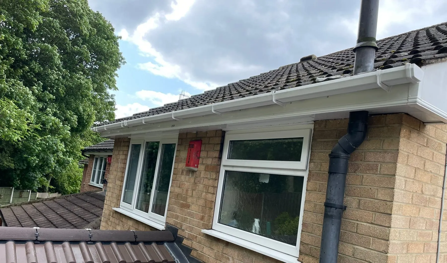 The same gutter and fascia cleared of moss and washed down